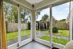 Bright corner window system overlooking a garden